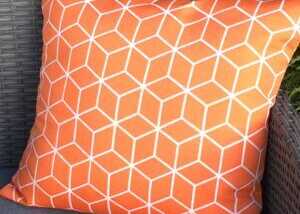 Orange cushion for teak garden furniture